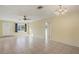 Open living room featuring tile flooring, a ceiling fan, and ample natural light at 865 Beverly Rd, Venice, FL 34293