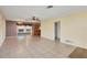 Tiled living room with ceiling fans, adjacent to a sunroom and kitchen at 865 Beverly Rd, Venice, FL 34293