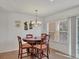 Bright dining area with wooden table and four chairs at 8954 White Sage, Lakewood Ranch, FL 34202