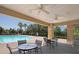 Community pool with patio tables and chairs under covered area at 8954 White Sage, Lakewood Ranch, FL 34202