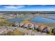 Aerial view of a block of single Gathering homes around a lake with lush landscaping at 10124 Silent Night Ln, Sarasota, FL 34241