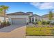 Charming single-story home featuring a tile roof, well-manicured lawn, and brick driveway at 10124 Silent Night Ln, Sarasota, FL 34241