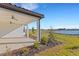 View of covered patio, landscaping and lake on a clear day at 10124 Silent Night Ln, Sarasota, FL 34241