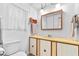 Simple bathroom with wood vanity, medicine cabinet, and toilet at 1111 49Th Avenue W Dr, Bradenton, FL 34207