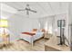 Bedroom with a double bed, ceiling fan, and a dresser at 1111 49Th Avenue W Dr, Bradenton, FL 34207