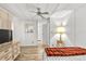 Spacious bedroom with a ceiling fan, dresser, and large windows at 1111 49Th Avenue W Dr, Bradenton, FL 34207