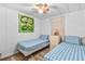 Bright bedroom with twin beds, dresser, and cheerful art at 1111 49Th Avenue W Dr, Bradenton, FL 34207