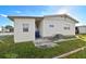Mobile home with AC unit and side yard at 1111 49Th Avenue W Dr, Bradenton, FL 34207