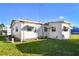Mobile home with a well-maintained lawn at 1111 49Th Avenue W Dr, Bradenton, FL 34207
