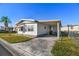 Side view of a manufactured home with covered patio at 1111 49Th Avenue W Dr, Bradenton, FL 34207