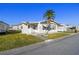 Single-wide manufactured home with carport and palm tree at 1111 49Th Avenue W Dr, Bradenton, FL 34207