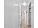 Long hallway with light walls and wood-look flooring at 1111 49Th Avenue W Dr, Bradenton, FL 34207
