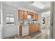 Kitchen with light wood cabinets, dishwasher, microwave, and exterior door access at 1111 49Th Avenue W Dr, Bradenton, FL 34207