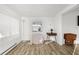 Living room featuring laminate floors, window, and a mid-century modern vibe at 1111 49Th Avenue W Dr, Bradenton, FL 34207