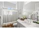 Neutral bathroom with shower, white vanity, and natural light at 13021 Indigo Way, Bradenton, FL 34211