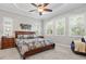 Comfortable bedroom features soft carpet, a ceiling fan, and plantation shutters at 13021 Indigo Way, Bradenton, FL 34211