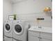 Organized laundry room with a washer, dryer, sink, and ample storage space at 13021 Indigo Way, Bradenton, FL 34211