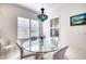 Elegant dining room with glass table, chandelier, and stylish seating at 13240 Sorrento Way, Bradenton, FL 34211