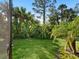 Green grassy backyard with tropical landscape at 153 Soliera St, Nokomis, FL 34275