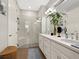 Modern bathroom with double vanity, walk-in shower, and white tile at 153 Soliera St, Nokomis, FL 34275
