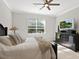 Bedroom with a queen-size bed, dresser, and large windows at 153 Soliera St, Nokomis, FL 34275