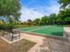 Outdoor bocce ball court with a bench and lush landscaping at 153 Soliera St, Nokomis, FL 34275