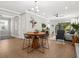 Dining area with a round wooden table and metal chairs, near the kitchen at 153 Soliera St, Nokomis, FL 34275