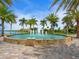 Circular fountain with palm trees and waterway views at 153 Soliera St, Nokomis, FL 34275