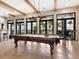 Game room with pool table and large windows overlooking the lake at 153 Soliera St, Nokomis, FL 34275
