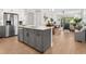 Kitchen island with gray cabinets, white countertops, and a sink at 153 Soliera St, Nokomis, FL 34275