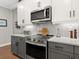 Modern kitchen with stainless steel appliances and white cabinets at 153 Soliera St, Nokomis, FL 34275