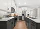 Modern kitchen with gray and white cabinets and stainless steel appliances at 153 Soliera St, Nokomis, FL 34275