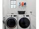Laundry room with washer, dryer, and extra storage at 153 Soliera St, Nokomis, FL 34275