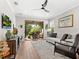 Living Room with grey couch, armchair and sliding doors to lanai at 153 Soliera St, Nokomis, FL 34275