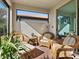 Bright screened porch with wicker furniture at 153 Soliera St, Nokomis, FL 34275