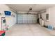 Two-car garage with storage shelving and water heater at 16351 Coconut Palm Dr, Port Charlotte, FL 33953