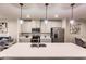 Modern kitchen island with white countertop, sink, and pendant lighting at 16351 Coconut Palm Dr, Port Charlotte, FL 33953