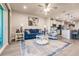 Open-concept living area with blue couch, ceiling fan, and view of the kitchen at 16351 Coconut Palm Dr, Port Charlotte, FL 33953