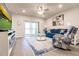 Comfortable living room with blue sofa and sliding glass doors at 16351 Coconut Palm Dr, Port Charlotte, FL 33953