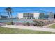 Community tennis courts with surrounding landscape at 1714 69Th W Ave # A207, Bradenton, FL 34207