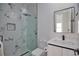 Modern bathroom with marble tile, glass shower, and floating vanity at 230 W Pine Valley Ln, Rotonda West, FL 33947