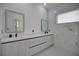 Modern bathroom with double vanity and marble tile at 230 W Pine Valley Ln, Rotonda West, FL 33947