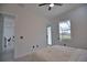 Bright bedroom with access to the backyard, featuring a neutral color palette and natural light at 230 W Pine Valley Ln, Rotonda West, FL 33947