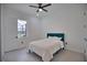 Cozy bedroom with teal headboard and ceiling fan at 230 W Pine Valley Ln, Rotonda West, FL 33947