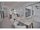 Modern dining area with access to the kitchen and pool area at 230 W Pine Valley Ln, Rotonda West, FL 33947