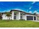 Modern two-story house with a two-car garage and manicured lawn at 230 W Pine Valley Ln, Rotonda West, FL 33947
