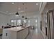 Modern kitchen with large island and stainless steel appliances at 230 W Pine Valley Ln, Rotonda West, FL 33947