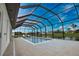 Enclosed pool and lanai with lounge chairs and canal view at 230 W Pine Valley Ln, Rotonda West, FL 33947