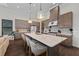 Modern kitchen with gray cabinets, white quartz countertops, and a large island at 232 Corelli Dr, Nokomis, FL 34275