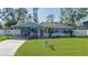 Charming light blue house with a lush green lawn at 335 49Th W St, Palmetto, FL 34221